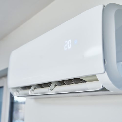 Adjusting temperature on air conditioner, Working air conditioner for comfort temperature in home at hot summer, cooling air in the room